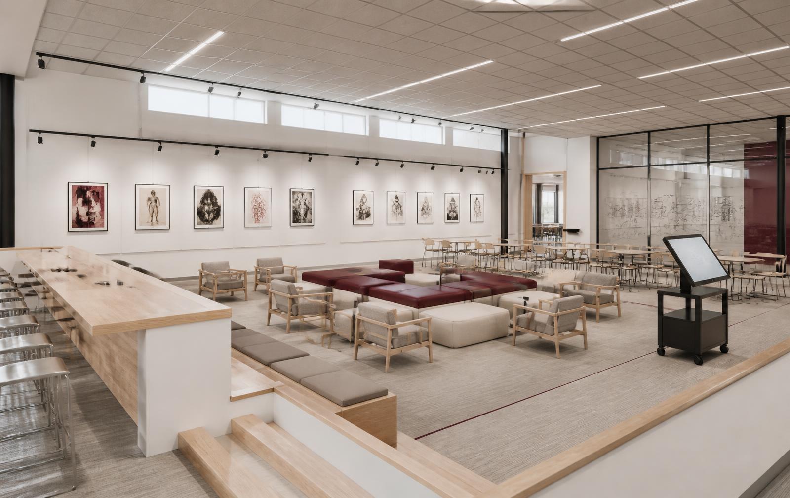 Gallery wall with framed student work, oxblood bench seating and mobile touchscreen cart