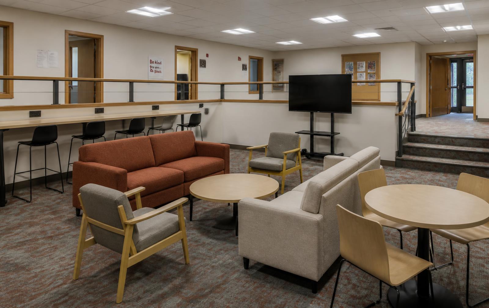 Cafe seating, rust banquette booth with interactive display and perimeter power counter